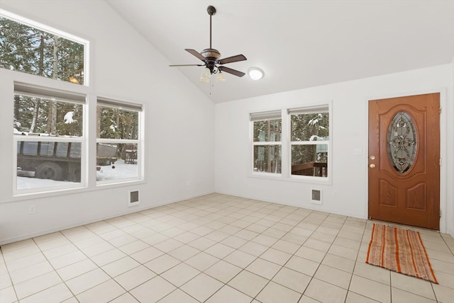 tiled entryway with ceiling fan and high vaulted ceiling