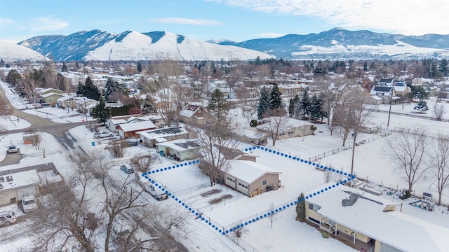 snowy aerial view with a mountain view