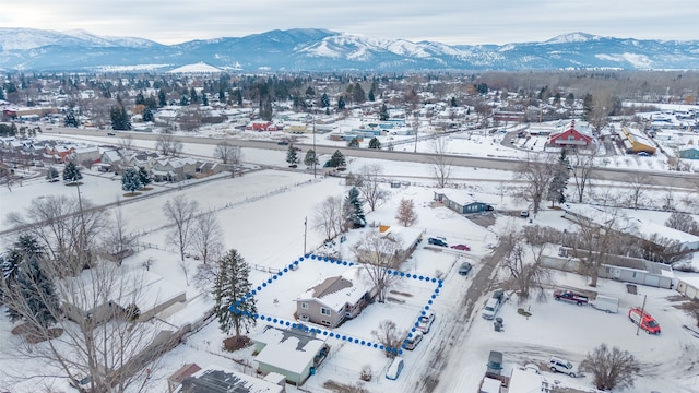 snowy aerial view with a mountain view