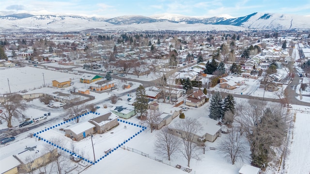 snowy aerial view with a mountain view