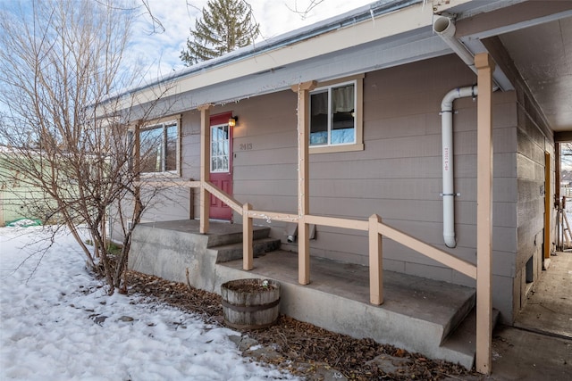 view of snow covered property entrance