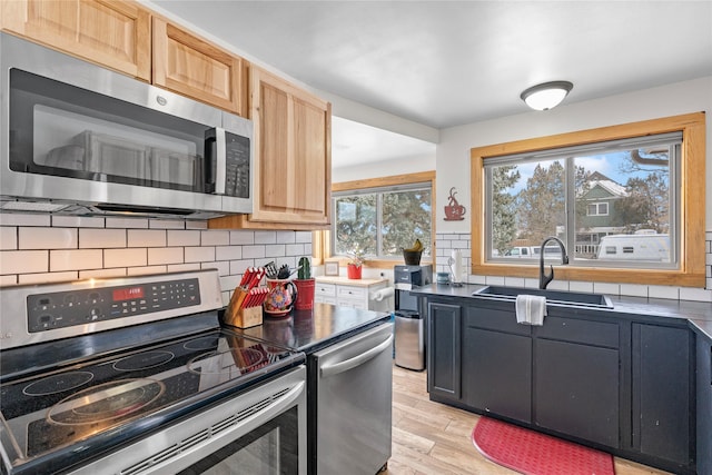 kitchen with sink, light brown cabinets, tasteful backsplash, and appliances with stainless steel finishes