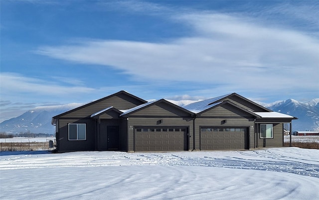 single story home featuring a garage and a mountain view