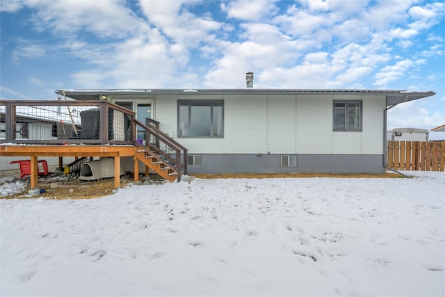607 Oregon St, Deer Lodge, MT 59722 - snow covered property featuring stairs and a wooden deck