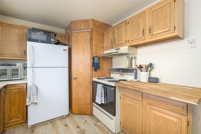 607 Oregon St, Deer Lodge, MT 59722 - kitchen featuring white appliances, under cabinet range hood, light wood-style flooring, and butcher block countertops