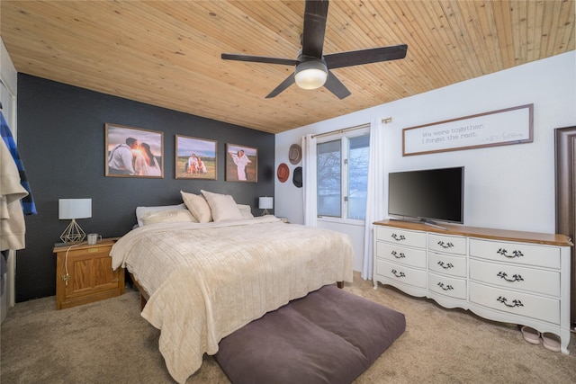 bedroom with ceiling fan, light colored carpet, and wooden ceiling