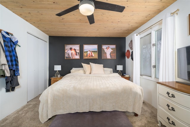 bedroom featuring ceiling fan, light colored carpet, wooden ceiling, and multiple windows