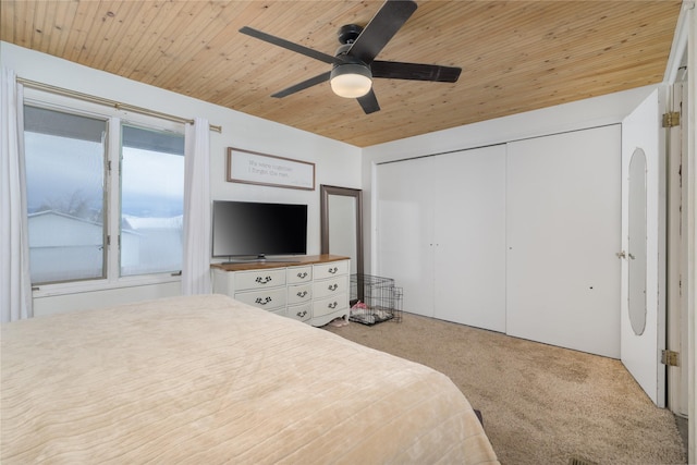 bedroom featuring ceiling fan, wooden ceiling, light carpet, and a closet