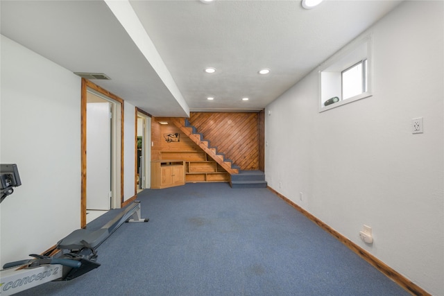 basement featuring wooden walls