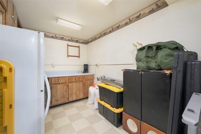 607 Oregon St, Deer Lodge, MT 59722 - kitchen with freestanding refrigerator, light flooring, brown cabinetry, and light countertops