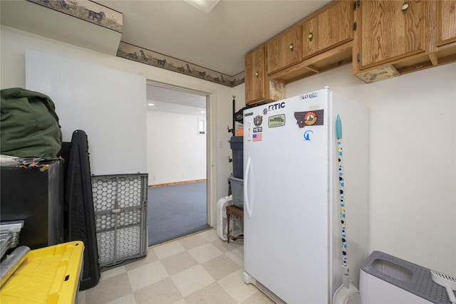 607 Oregon St, Deer Lodge, MT 59722 - kitchen with light flooring, brown cabinetry, and freestanding refrigerator