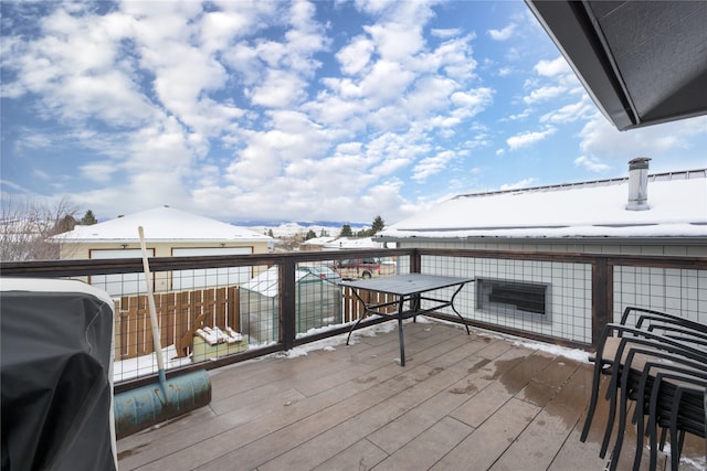 snow covered deck featuring a grill