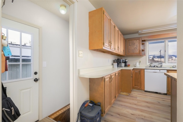 607 Oregon St, Deer Lodge, MT 59722 - kitchen with white dishwasher, light wood-type flooring, and light countertops