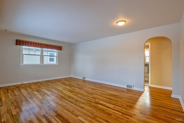 unfurnished room with a wealth of natural light and light hardwood / wood-style flooring