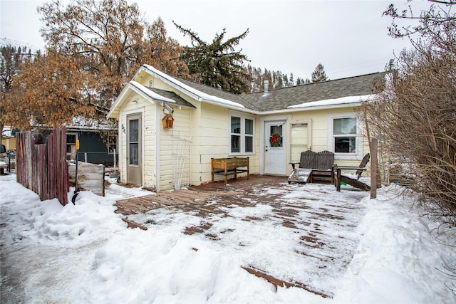 view of snow covered rear of property