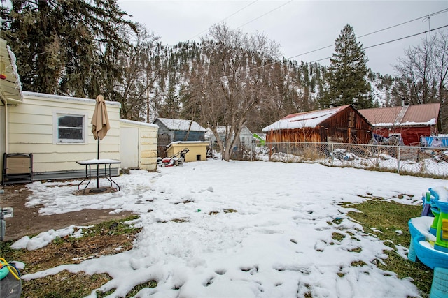 view of yard layered in snow