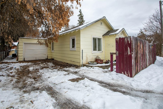 snow covered property featuring a garage