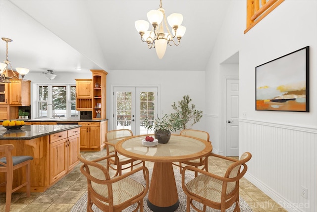 dining space featuring a notable chandelier, french doors, and lofted ceiling