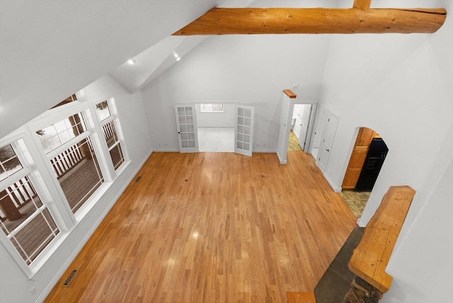 bonus room featuring high vaulted ceiling, light hardwood / wood-style floors, and beamed ceiling