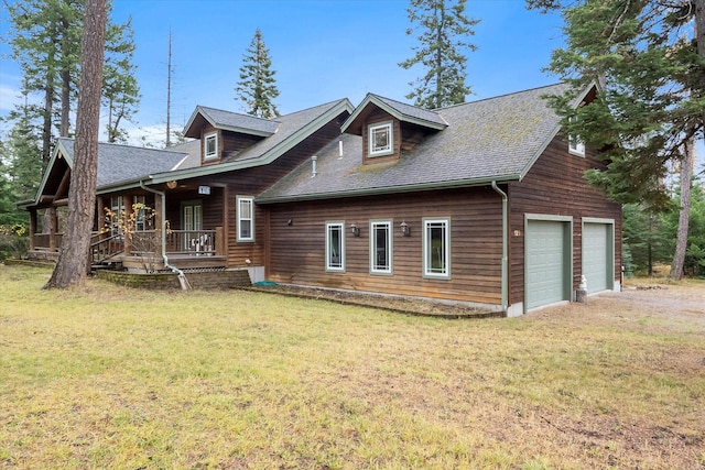 exterior space with a yard, covered porch, and a garage