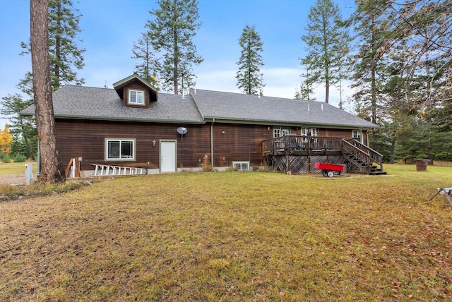 rear view of house featuring a lawn and a wooden deck