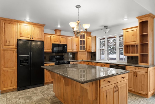 kitchen with sink, an inviting chandelier, decorative backsplash, a kitchen island, and black appliances