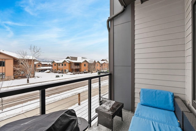 view of snow covered back of property