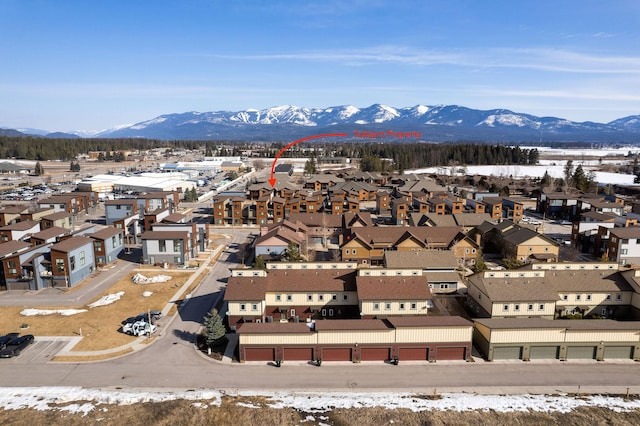 snowy aerial view with a mountain view