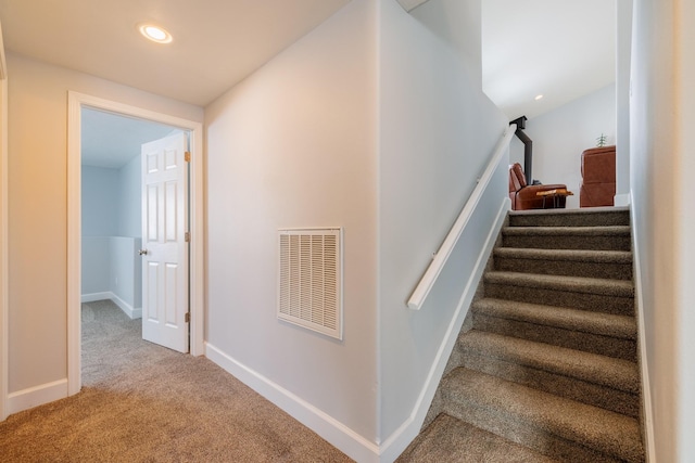 stairs featuring visible vents, recessed lighting, baseboards, and carpet