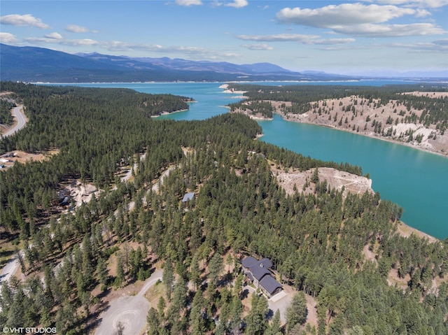 drone / aerial view featuring a water and mountain view