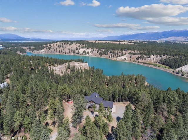 birds eye view of property with a water and mountain view