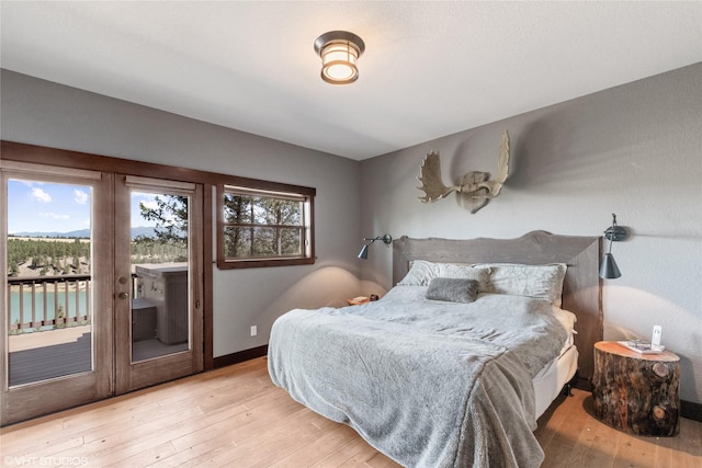 bedroom featuring access to outside and light hardwood / wood-style flooring