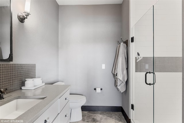 bathroom with toilet, decorative backsplash, walk in shower, and vanity