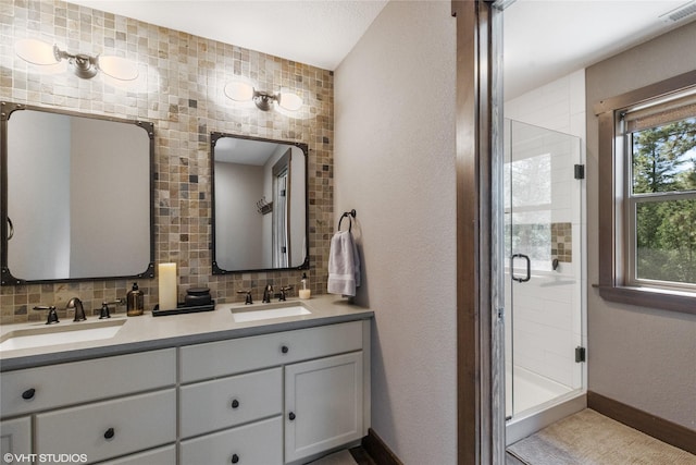 bathroom featuring a shower with shower door, backsplash, and vanity