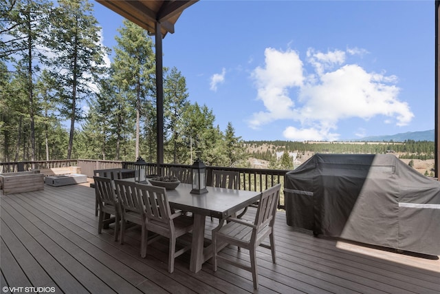 wooden terrace featuring area for grilling and a mountain view