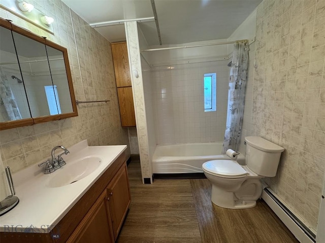 full bathroom featuring a baseboard radiator, tile walls, shower / tub combo, wood-type flooring, and vanity