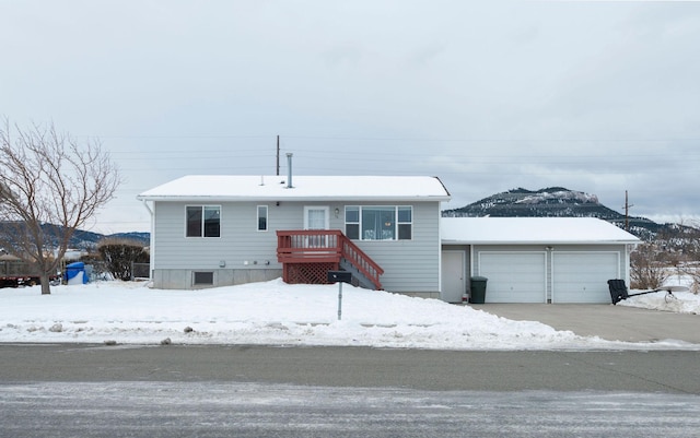 view of front of property featuring a garage and a mountain view