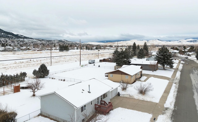 snowy aerial view with a mountain view