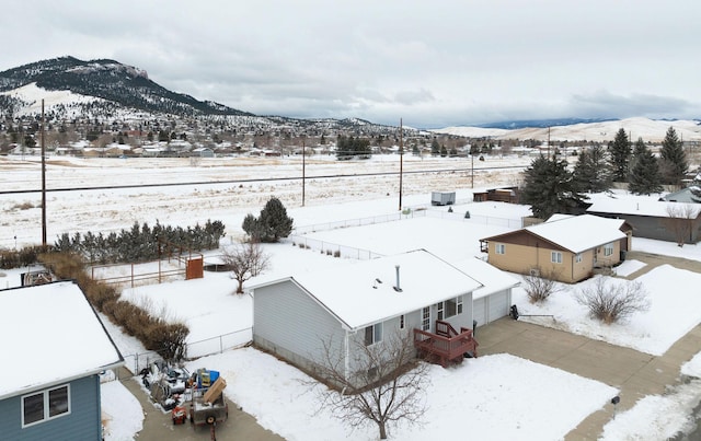 snowy aerial view featuring a mountain view