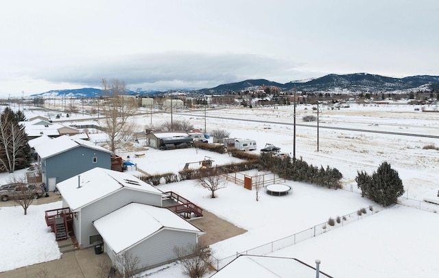 snowy aerial view featuring a mountain view