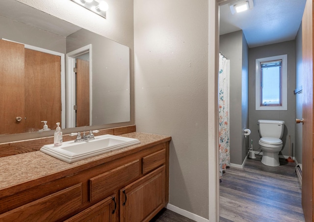 bathroom featuring toilet, wood-type flooring, and vanity