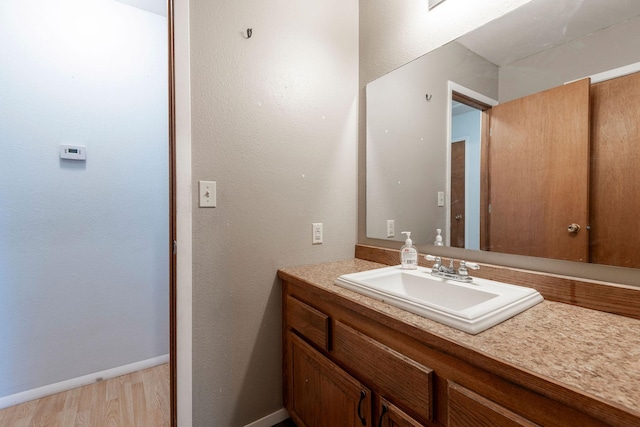 bathroom featuring vanity and hardwood / wood-style flooring