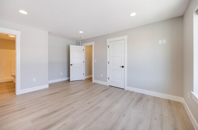 empty room with light hardwood / wood-style floors