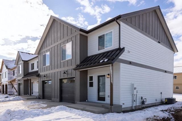 exterior space with a garage and central air condition unit