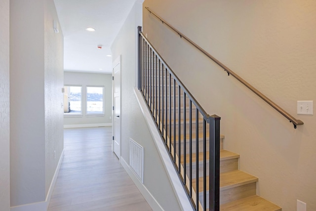 staircase featuring hardwood / wood-style floors