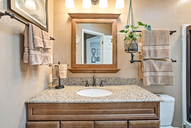 bathroom featuring toilet and vanity