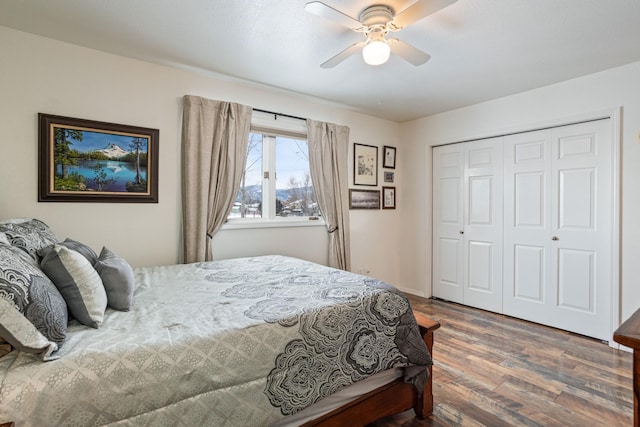 bedroom featuring dark hardwood / wood-style flooring, ceiling fan, and a closet