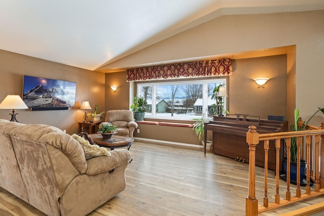 living room with lofted ceiling and light hardwood / wood-style flooring