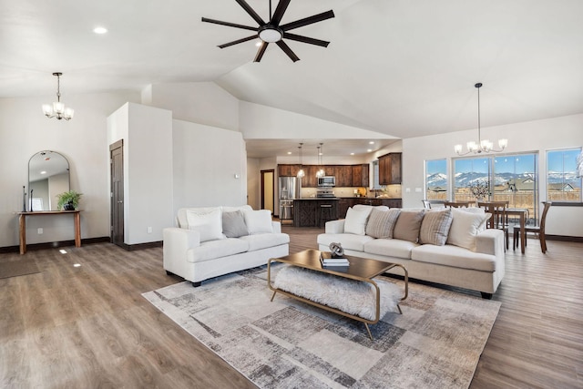 living room featuring an inviting chandelier, recessed lighting, light wood-style floors, and baseboards