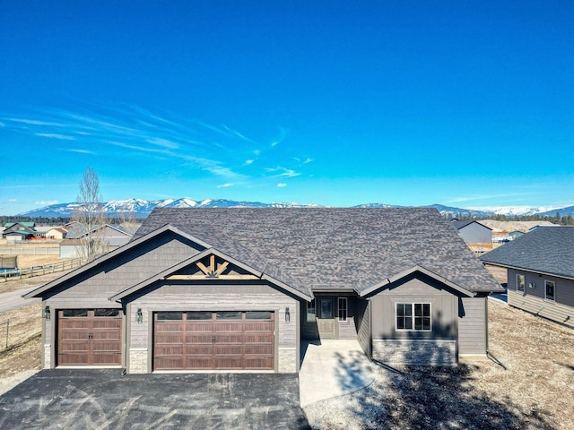 view of front of home featuring a mountain view, an attached garage, and aphalt driveway